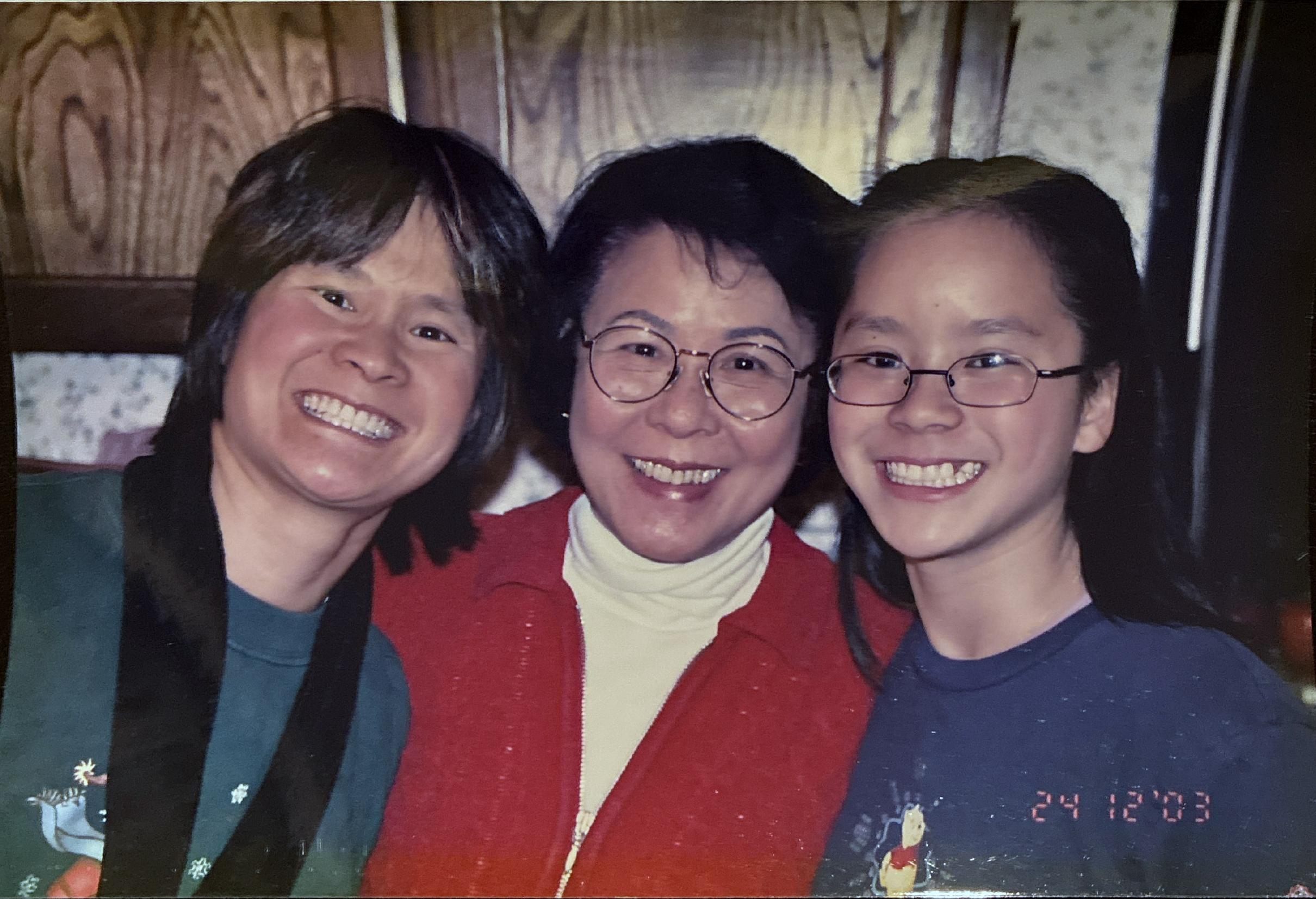 Rebecca as a young girl smiling with her mother and grandmother