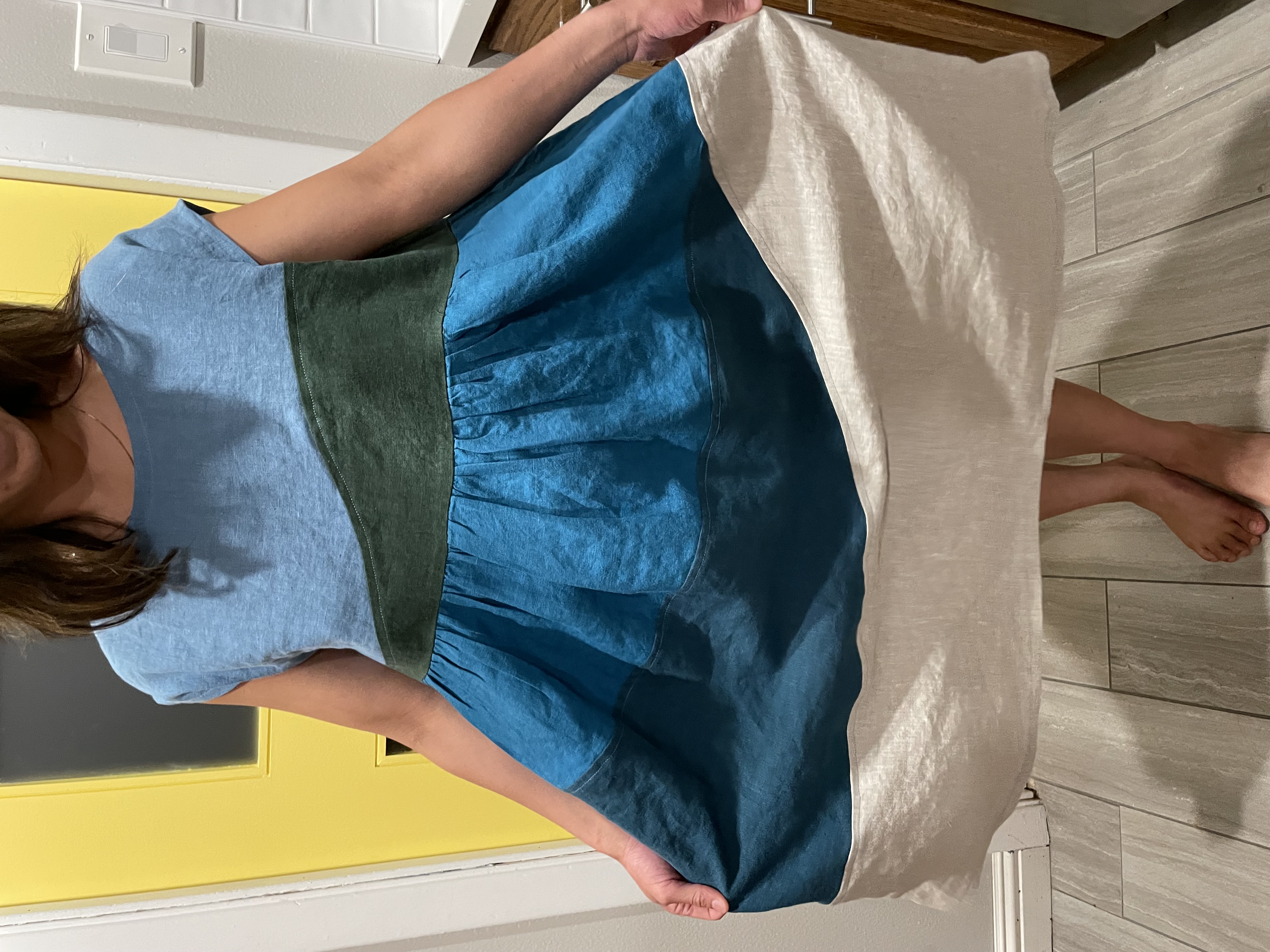 Loose fitting dress with blues, greens, and natural colors